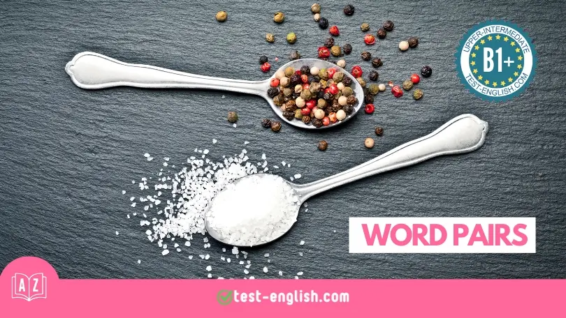 Two silver spoons with salt and pepper on a black slate background, representing the concept of word pairs in a B1+ English vocabulary lesson.